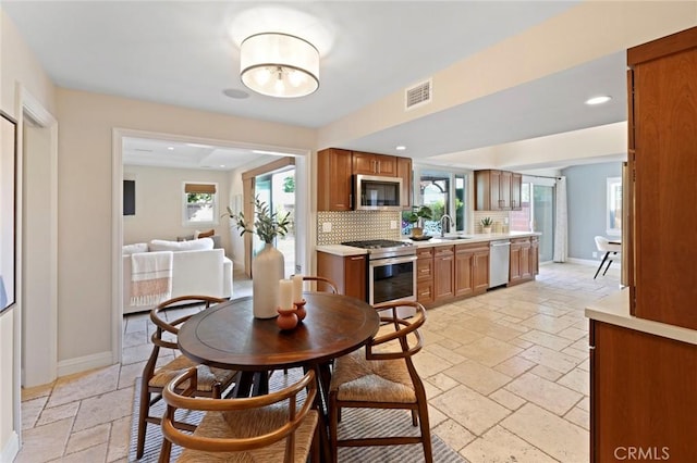 2662 Salmon Dr, Los Alamitos, CA 90720 - dining room featuring stone tile floors, healthy amount of natural light, recessed lighting, and baseboards