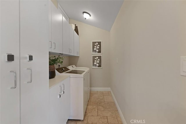 2662 Salmon Dr, Los Alamitos, CA 90720 - laundry room featuring cabinet space, washing machine and clothes dryer, stone tile floors, and baseboards