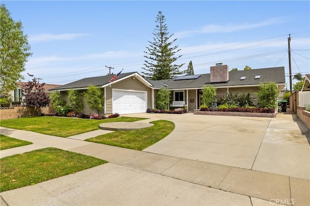 2662 Salmon Dr, Los Alamitos, CA 90720 - ranch-style home featuring a garage, roof mounted solar panels, a chimney, and concrete driveway