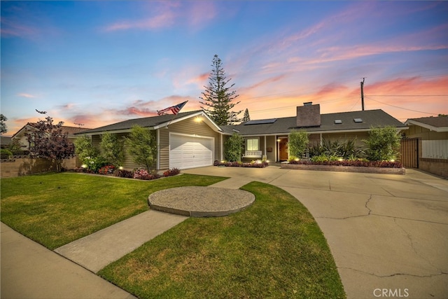 2662 Salmon Dr, Los Alamitos, CA 90720 - ranch-style house featuring roof mounted solar panels, an attached garage, driveway, and a chimney