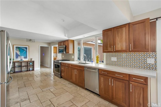2662 Salmon Dr, Los Alamitos, CA 90720 - kitchen with appliances with stainless steel finishes, a sink, tasteful backsplash, light countertops, and brown cabinetry