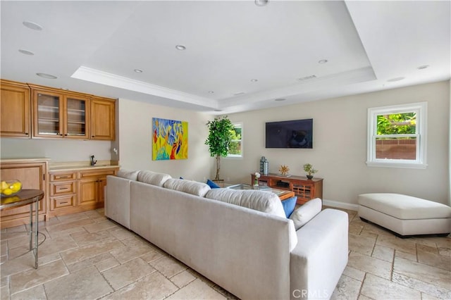 2662 Salmon Dr, Los Alamitos, CA 90720 - living room featuring a tray ceiling, stone tile floors, and baseboards