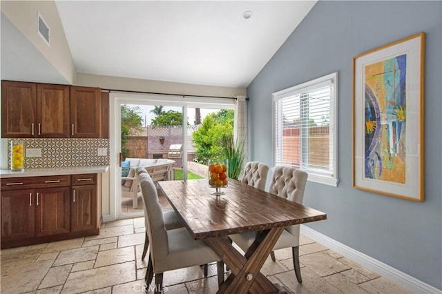 2662 Salmon Dr, Los Alamitos, CA 90720 - dining area featuring stone tile floors, vaulted ceiling, and baseboards