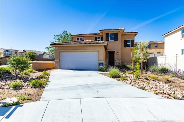 13119 Lancaster St, Hesperia, CA 92344 - view of front facade featuring stone siding, stucco siding, a garage, a tiled roof, and driveway