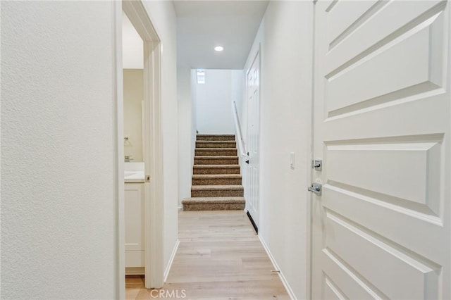 13119 Lancaster St, Hesperia, CA 92344 - corridor featuring light wood finished floors, stairs, recessed lighting, and baseboards