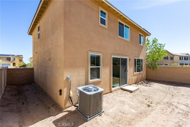 13119 Lancaster St, Hesperia, CA 92344 - rear view of house featuring stucco siding, a fenced backyard, central AC unit, and a patio area