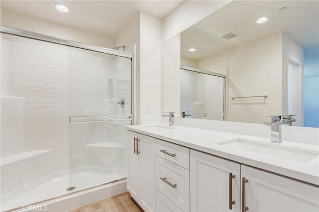 13119 Lancaster St, Hesperia, CA 92344 - full bath with a stall shower, double vanity, wood finished floors, and recessed lighting