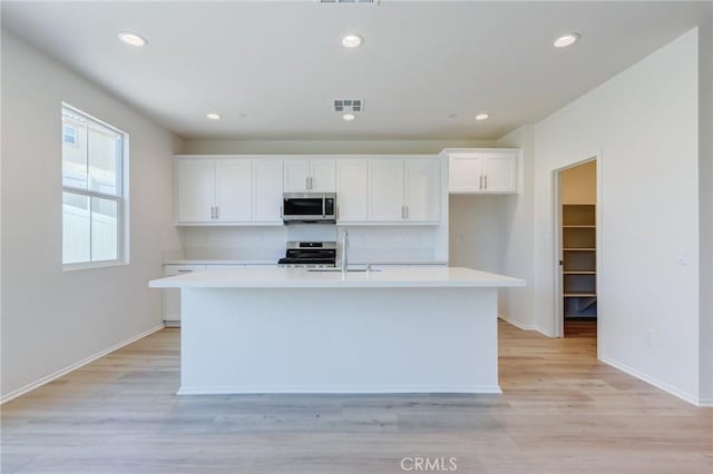 13119 Lancaster St, Hesperia, CA 92344 - kitchen featuring stainless steel appliances, a sink, light countertops, white cabinetry, and recessed lighting