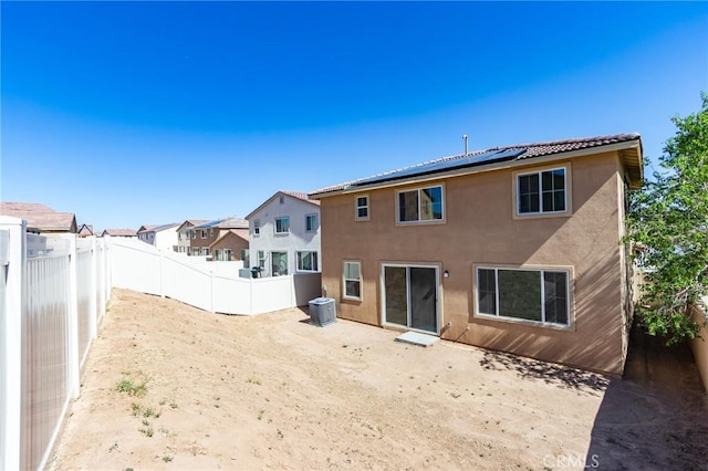 13119 Lancaster St, Hesperia, CA 92344 - rear view of property featuring stucco siding, solar panels, a fenced backyard, and a residential view