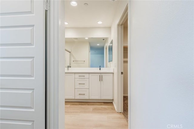 13119 Lancaster St, Hesperia, CA 92344 - full bathroom featuring double vanity, wood finished floors, recessed lighting, and a spacious closet