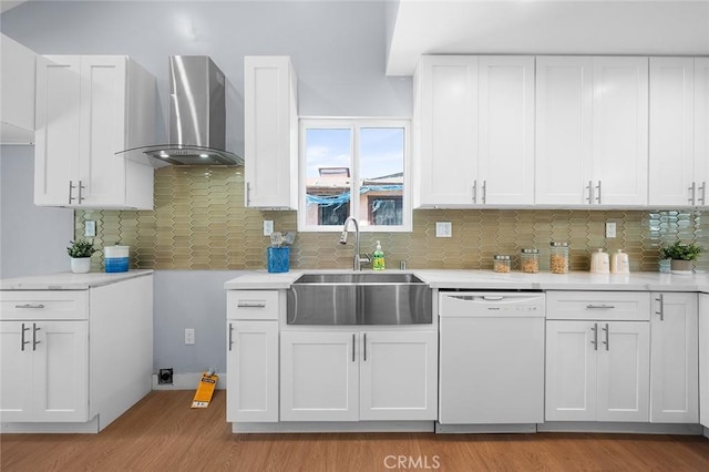 1223 W 90th St, Los Angeles, CA 90044 - kitchen with white dishwasher, wall chimney exhaust hood, a sink, light wood finished floors, and light countertops