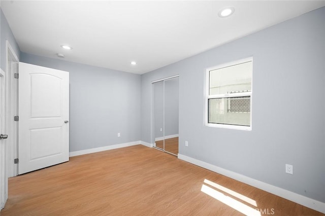 1223 W 90th St, Los Angeles, CA 90044 - unfurnished bedroom featuring light wood-style floors, baseboards, recessed lighting, and a closet