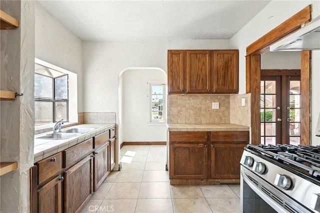 541 Randolph St, Pomona, CA 91768 - kitchen featuring tile countertops, healthy amount of natural light, custom exhaust hood, and light tile patterned floors