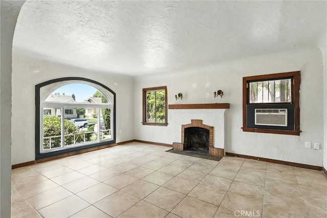 541 Randolph St, Pomona, CA 91768 - unfurnished living room featuring tile patterned floors, a fireplace with flush hearth, a textured ceiling, and cooling unit