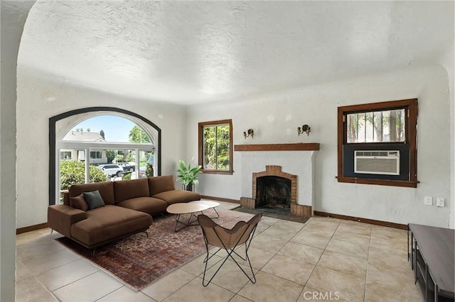 541 Randolph St, Pomona, CA 91768 - living room with light tile patterned floors, cooling unit, a brick fireplace, and a textured ceiling