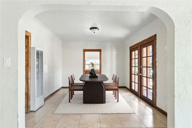541 Randolph St, Pomona, CA 91768 - dining space featuring a heating unit, french doors, a textured wall, plenty of natural light, and arched walkways