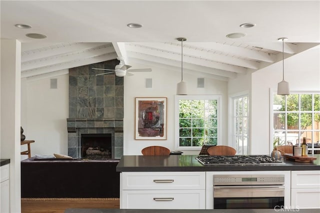 1307 Oxford Ln, Newport Beach, CA 92660 - kitchen with stainless steel appliances, dark countertops, white cabinetry, and a ceiling fan