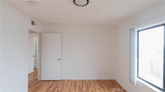14610 Erwin St, Van Nuys, CA 91411 - spare room featuring plenty of natural light, light wood-style floors, a textured ceiling, and baseboards