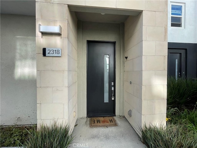 2318 Synergy, Irvine, CA 92614 - view of exterior entry featuring concrete block siding and elevator