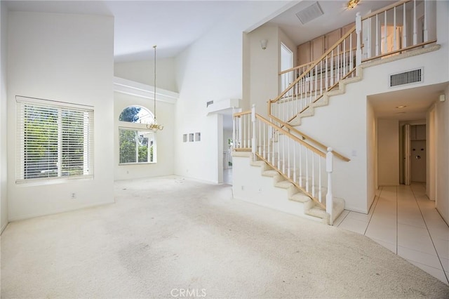 24177 Morning Dove Ln, Murrieta, CA 92562 - unfurnished living room with high vaulted ceiling, stairway, carpet flooring, baseboards, and tile patterned flooring
