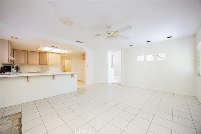 24177 Morning Dove Ln, Murrieta, CA 92562 - kitchen featuring light countertops, open floor plan, a kitchen breakfast bar, a peninsula, and ceiling fan