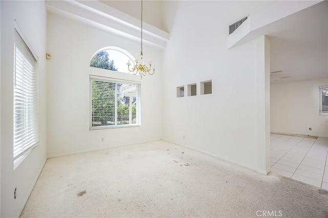 24177 Morning Dove Ln, Murrieta, CA 92562 - carpeted empty room with a chandelier, baseboards, and a towering ceiling