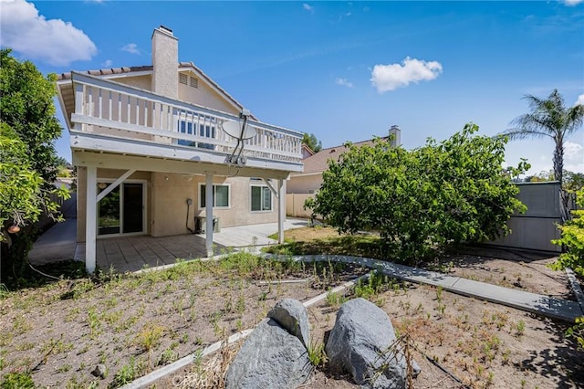 24177 Morning Dove Ln, Murrieta, CA 92562 - back of house featuring a patio, a wooden deck, stucco siding, and a chimney