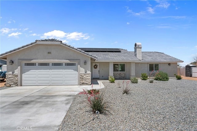 21044 Wisteria St, Apple Valley, CA 92308 - ranch-style house with stucco siding, an attached garage, a tile roof, concrete driveway, and solar panels