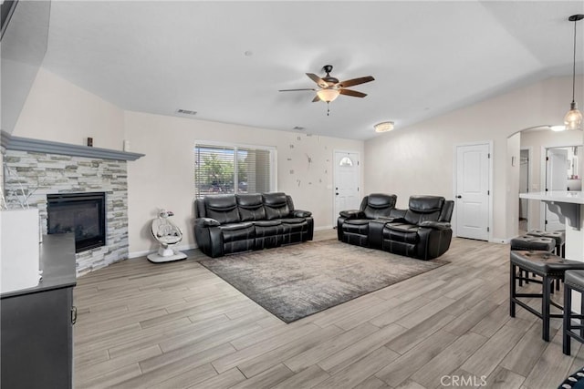21044 Wisteria St, Apple Valley, CA 92308 - living room with ceiling fan, light wood-style flooring, arched walkways, lofted ceiling, and a fireplace