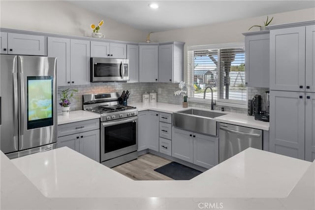 21044 Wisteria St, Apple Valley, CA 92308 - kitchen with stainless steel appliances, a sink, backsplash, gray cabinetry, and recessed lighting