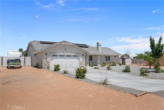 21044 Wisteria St, Apple Valley, CA 92308 - ranch-style home featuring stucco siding, driveway, a garage, and solar panels