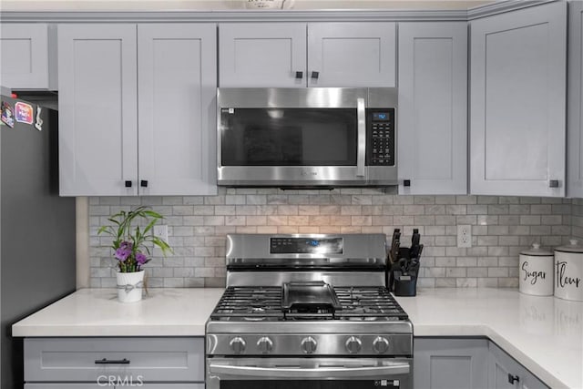 21044 Wisteria St, Apple Valley, CA 92308 - kitchen featuring appliances with stainless steel finishes, tasteful backsplash, and gray cabinets