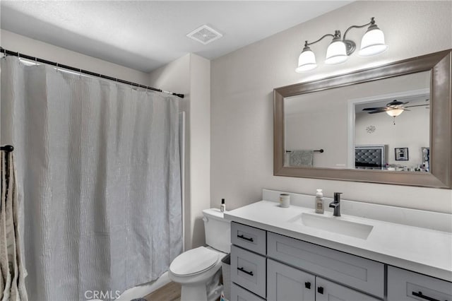 21044 Wisteria St, Apple Valley, CA 92308 - full bathroom featuring vanity, toilet, ceiling fan, and a shower with curtain