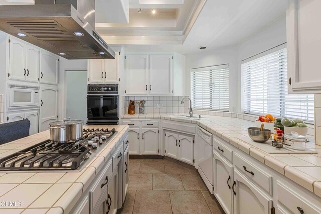 14000 Castlemaine Ave, Bakersfield, CA 93314 - kitchen with extractor fan, white appliances, tile countertops, decorative backsplash, and white cabinetry
