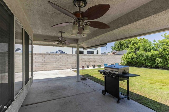 14000 Castlemaine Ave, Bakersfield, CA 93314 - fenced backyard with a ceiling fan, a patio area, and area for grilling
