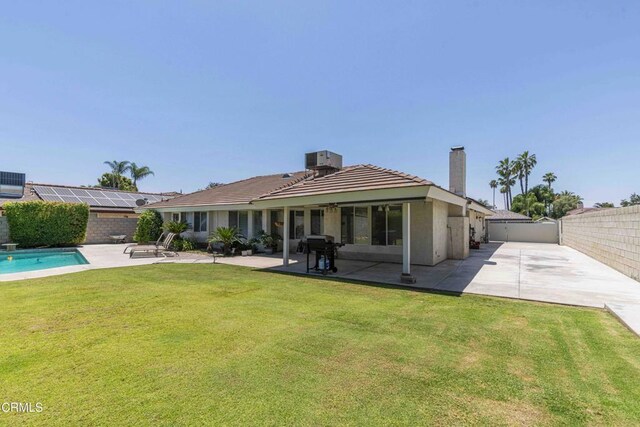 14000 Castlemaine Ave, Bakersfield, CA 93314 - rear view of property with a chimney, a fenced backyard, a patio, a tile roof, and driveway
