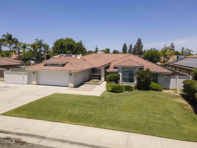 14000 Castlemaine Ave, Bakersfield, CA 93314 - ranch-style home featuring a tiled roof, concrete driveway, an attached garage, roof mounted solar panels, and stucco siding