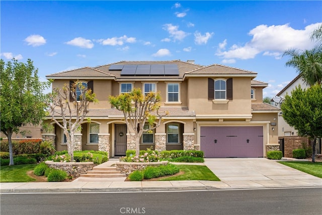 8243 Fall Creek Dr, Eastvale, CA 92880 - view of front of home featuring stucco siding, a garage, solar panels, stone siding, and concrete driveway