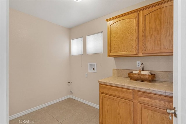 19410 Allegheny Ct, Apple Valley, CA 92307 - laundry room featuring cabinet space, hookup for a washing machine, baseboards, light tile patterned flooring, and hookup for a gas dryer