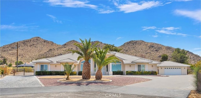19410 Allegheny Ct, Apple Valley, CA 92307 - view of front of property with a mountain view, driveway, stucco siding, a tile roof, and a gate