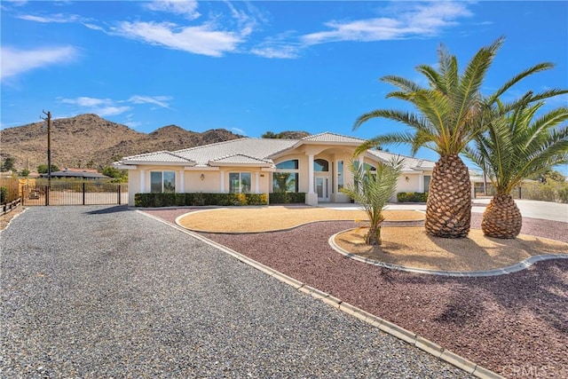 19410 Allegheny Ct, Apple Valley, CA 92307 - mediterranean / spanish-style house with a mountain view, stucco siding, a gate, driveway, and a tile roof