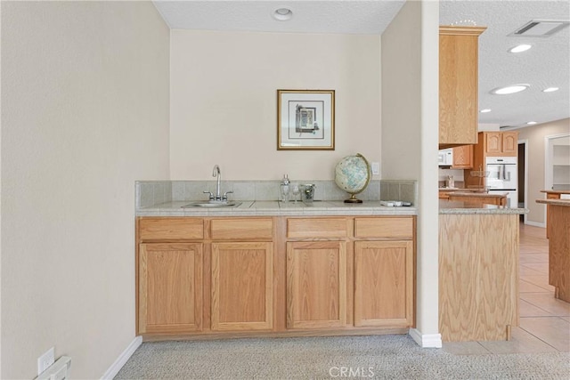 19410 Allegheny Ct, Apple Valley, CA 92307 - bar area featuring a sink, white double oven, light tile patterned floors, recessed lighting, and baseboards