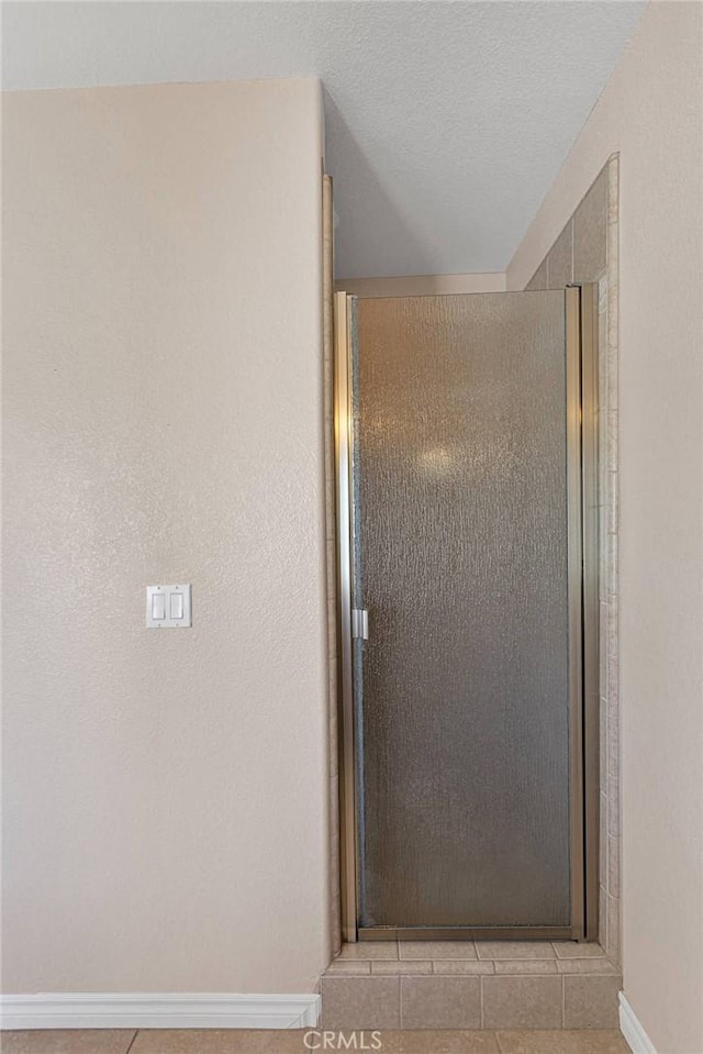 19410 Allegheny Ct, Apple Valley, CA 92307 - bathroom featuring baseboards, a stall shower, and tile patterned flooring