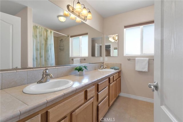 19410 Allegheny Ct, Apple Valley, CA 92307 - full bathroom with double vanity, baseboards, tiled shower, and tile patterned floors