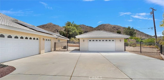19410 Allegheny Ct, Apple Valley, CA 92307 - garage with a mountain view, a gate, and roof mounted solar panels