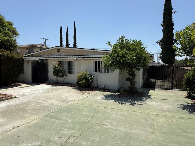 4639 Flora St, Montclair, CA 91763 - view of front of house featuring stucco siding and a gate