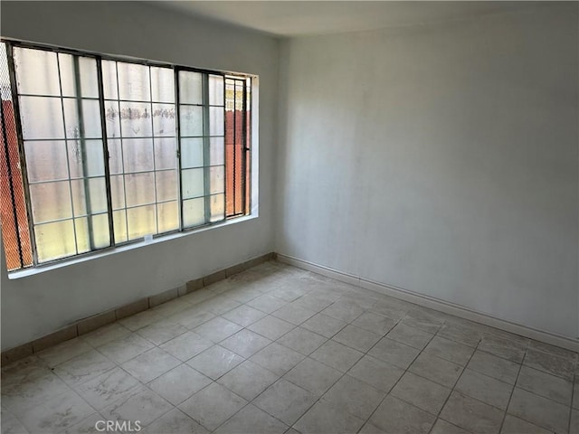 4639 Flora St, Montclair, CA 91763 - tiled spare room with healthy amount of natural light and baseboards