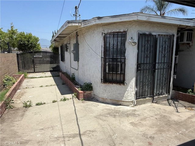 4639 Flora St, Montclair, CA 91763 - view of side of property featuring a gate and stucco siding