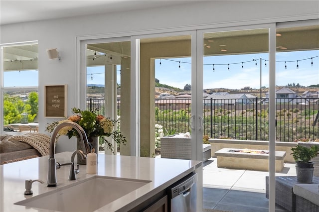 32325 Hillstone St, Temecula, CA 92591 - kitchen with a sink, healthy amount of natural light, stainless steel dishwasher, and light countertops