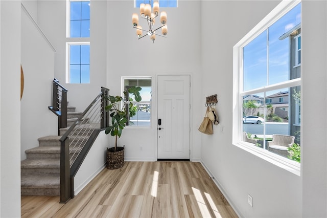 32325 Hillstone St, Temecula, CA 92591 - foyer featuring a towering ceiling, wood finished floors, a chandelier, stairway, and plenty of natural light